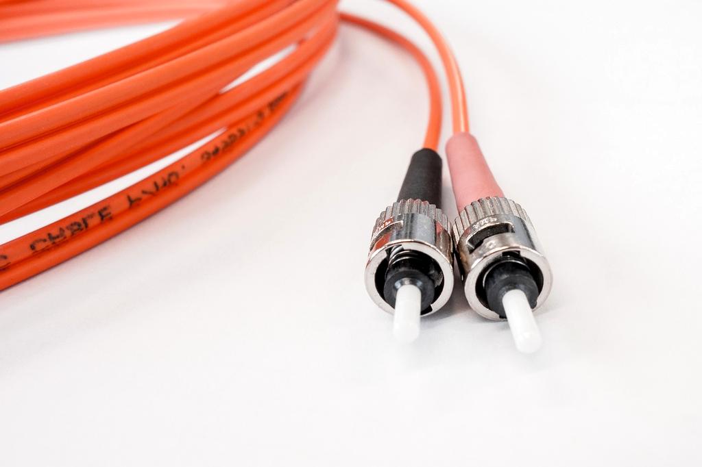 Technician working on fibre optic cables in a city street